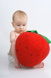 Child with plushy strawberry.