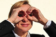 businesswoman pretending to look through binoculars