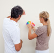 Couple choosing a color to paint a room