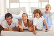Laughing parents playing with their children
