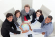 High angle of a diverse business team holding a terrestrial glob