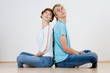 Couple sitting back to back