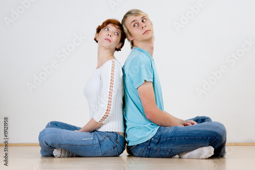 Photo: Couple sitting back to back Couple sitting back to back