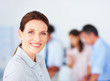 Beautiful business woman with colleagues at the background