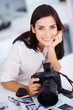 Young pretty female photographer with her camera