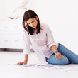 Cute female working on photographs for a news paper while seated