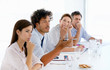 Foto: Young business colleagues working on a document, focus on man Young business colleagues working on a document, focus on man