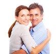 A charming married couple embracing over white background