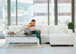 Cute elderly couple at home shopping with their credit card from