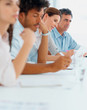 Business people making a note during seminar