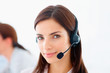 Portrait of a pretty young customer representative wearing heads