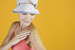 A Young Woman Rubbing Suntan Cream Into Her Arm