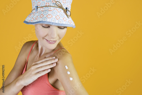 Photo: A Young Woman Rubbing Suntan Cream Into Her Arm A Young Woman Rubbing Suntan Cream Into Her Arm