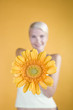 A Young Woman Holding An Orange Flower