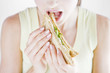 A Young Woman Eating A Sandwich
