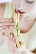 A Young Woman Eating A Sandwich