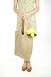 A Young Woman Carrying A Bunch Of Yellow Roses In A Shopping Bag