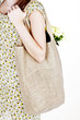A Young Woman Carrying A Shopping Bag Over Her Shoulder