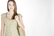 A Young Woman Carrying A Shopping Bag Over Her Shoulder
