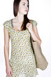 A Young Woman Carrying A Shopping Bag Over Her Shoulder