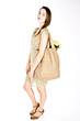 A Young Woman Carrying A Shopping Bag Over Her Shoulder