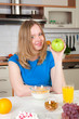 Young positive woman with green apple in hand Young positive woman with green apple in hand