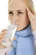 Woman taking a medicine.