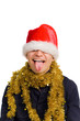 young man in a santa hat puts out the tongue