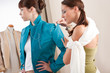 Model fitting by female fashion designer