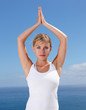 Pretty with hands joined , practicing yoga outdoors