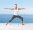 Pretty young woman stretching on a porch outdoors