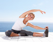 Happy woman stretching out while outside on a porch