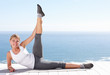 Happy female stretching her legs while on a porch outdoors
