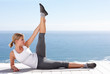 Pretty female stretching her legs while on a porch outdoors