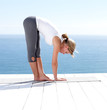 Woman doing stretching exercises on a porch