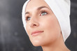 Closeup of a young woman looking away , towel wrapped on head
