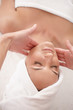 Top view of a young woman getting a facial massage