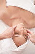 Top view of a young female enjoying a face massage