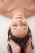 Top view of a female receiving a head massage at spa