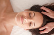 Top view of a cute female receiving a head massage at spa