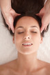 Top view closeup of a cute female receiving a head massage
