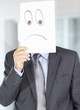 Business man holding a sad face , expressing emotion