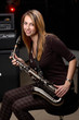young female play in study on  saxophone