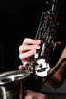 hand on buttons of saxophone
