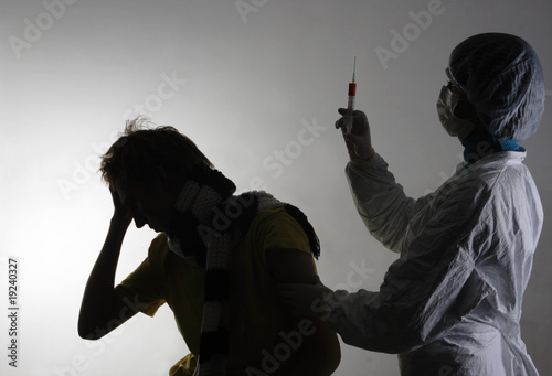 Man getting a flu shot from his doctor. Isolated on white