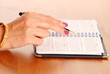 Female hand with pen and executive diary