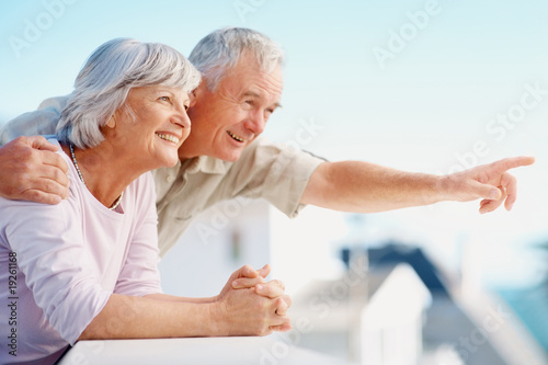 Photo: Old man pointing out to something interesting to his wife Old man pointing out to something interesting to his wife