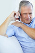Happy elderly man conversing over the cellphone
