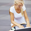 Girl using a computer laptop at an outdoor cafŽ