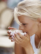 Portrait of a young woman drinking coffee
